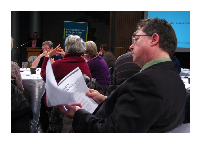 Bob Jonkman looking through the Basic Income handout.